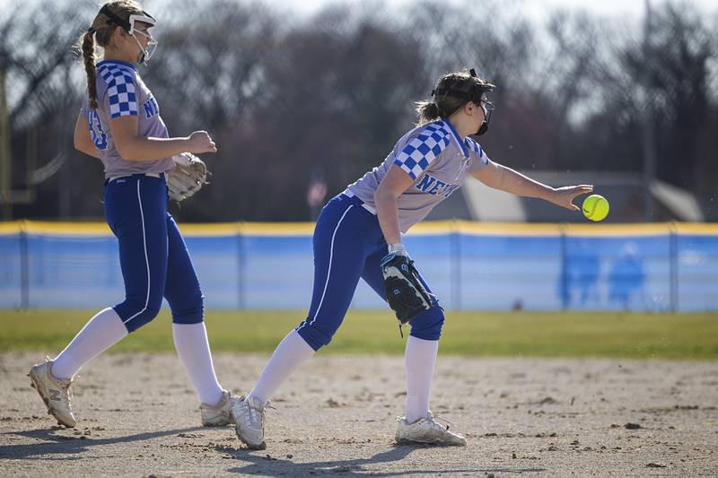 Newman’s Lucy Oetting shovels to first for an out against Forreston Monday, March 11, 2024.