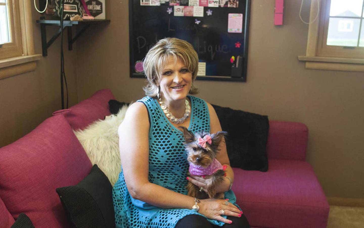 Elizabeth Oparyk and her dog Dallas are pictured at Lizzy's Pink Boutique, Oparyk's shop inside her home at 367 E. Ottawa St. in Sycamore. The boutique is open Tuesday through Saturday by appointment only.