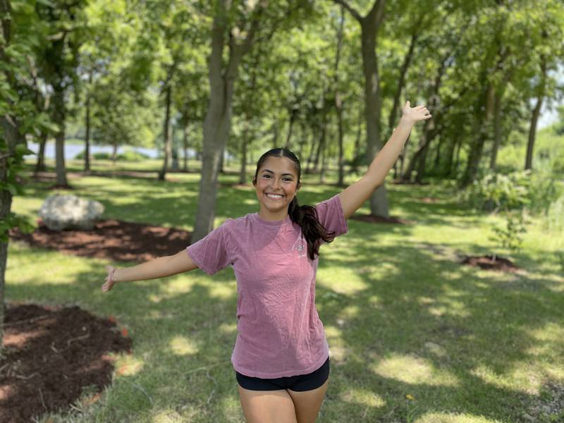 Anita Werderich, a senior at Yorkville High School, celebrates the planting of 40 new trees in Yorkville’s Riverfront Park along the Fox River. Native tree species were chosen to create a more natural and diverse woodland ecosystem.