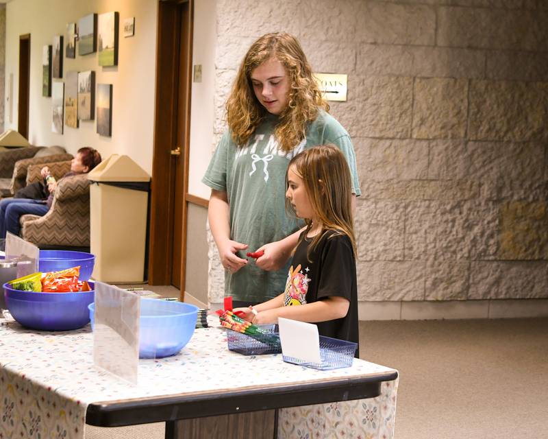 Reagan Borx, 8, and sister Tayler Borx, 12, of Sycamore check out the prize table on Sunday Oct. 12, 2025, to exchange their tickets during the DeKalb County 4-H carnival held at the DeKalb County Farm Bureau in Sycamore.
