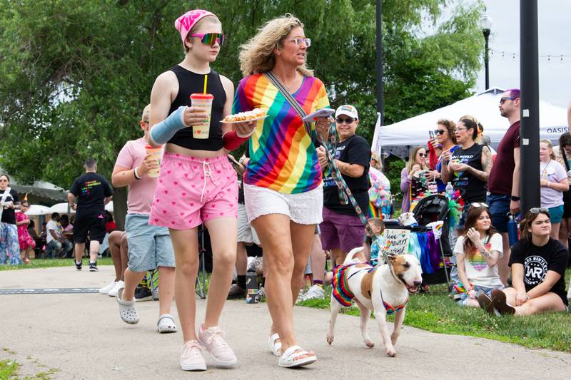 Paraders walk dog on Saturday, June 8, 2024 at Jordan Block Park in Ottawa.