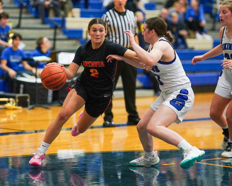 Batavia's Brooke Carlson (2) drives to the basket against Geneva’s Gabby Webb (12) during a basketball game at Geneva High School on Friday, Dec 15, 2023.