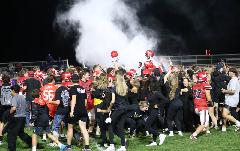 Hall footbal players celebrate with super fans after defeating Sherrard during Homecoming night on Friday, Sept. 19, 2025 at Richard Nesti Stadium.