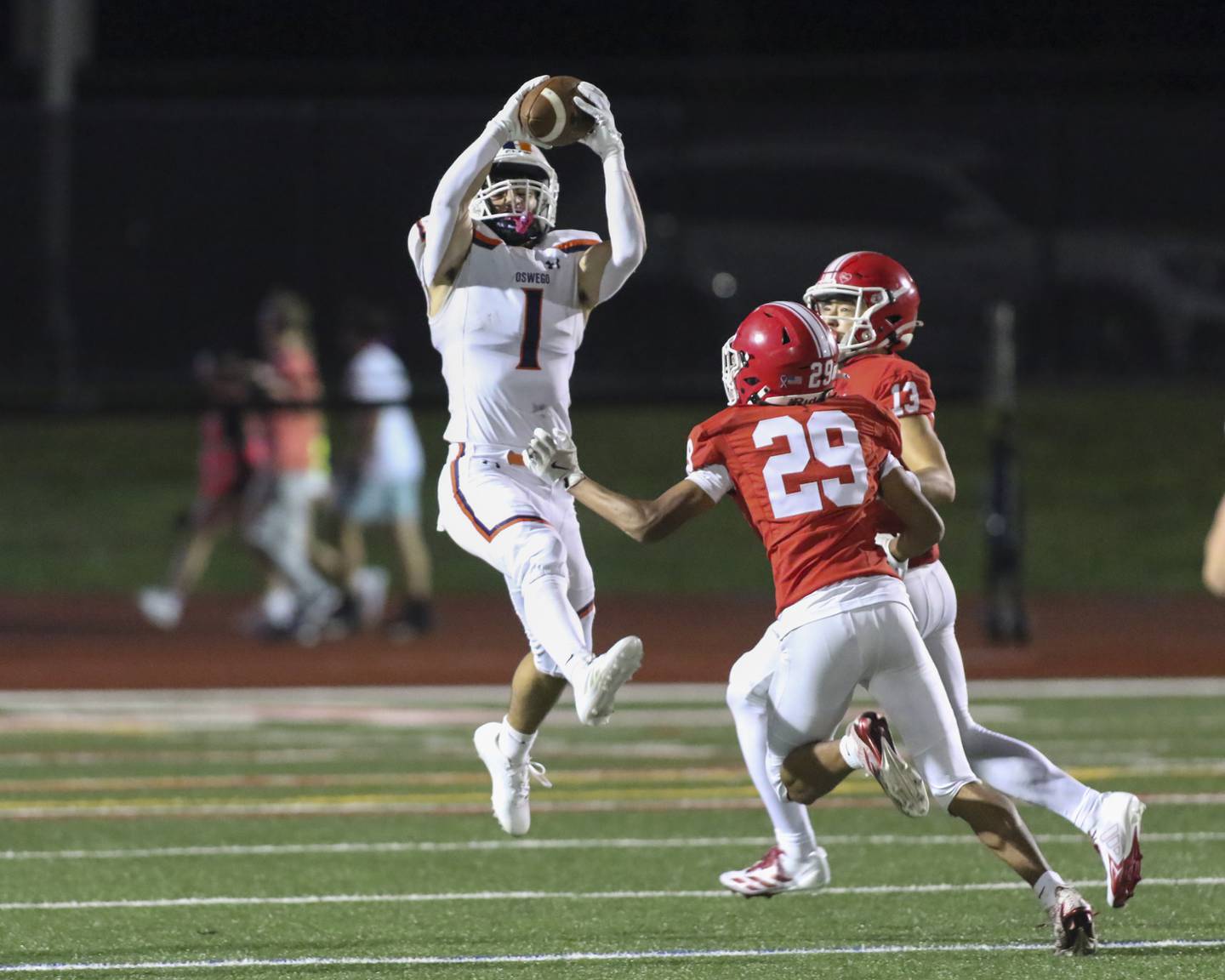 Oswego's Teddy (Theodore) Manikas (1) comes down with a catch during football game between Oswego at Naperville Central  on Friday, Aug 29, 2025  in Naperville.