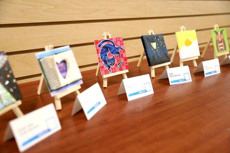 Art work done on small canvasses by early childhood students through adults is on display at the Westmont Public Library.