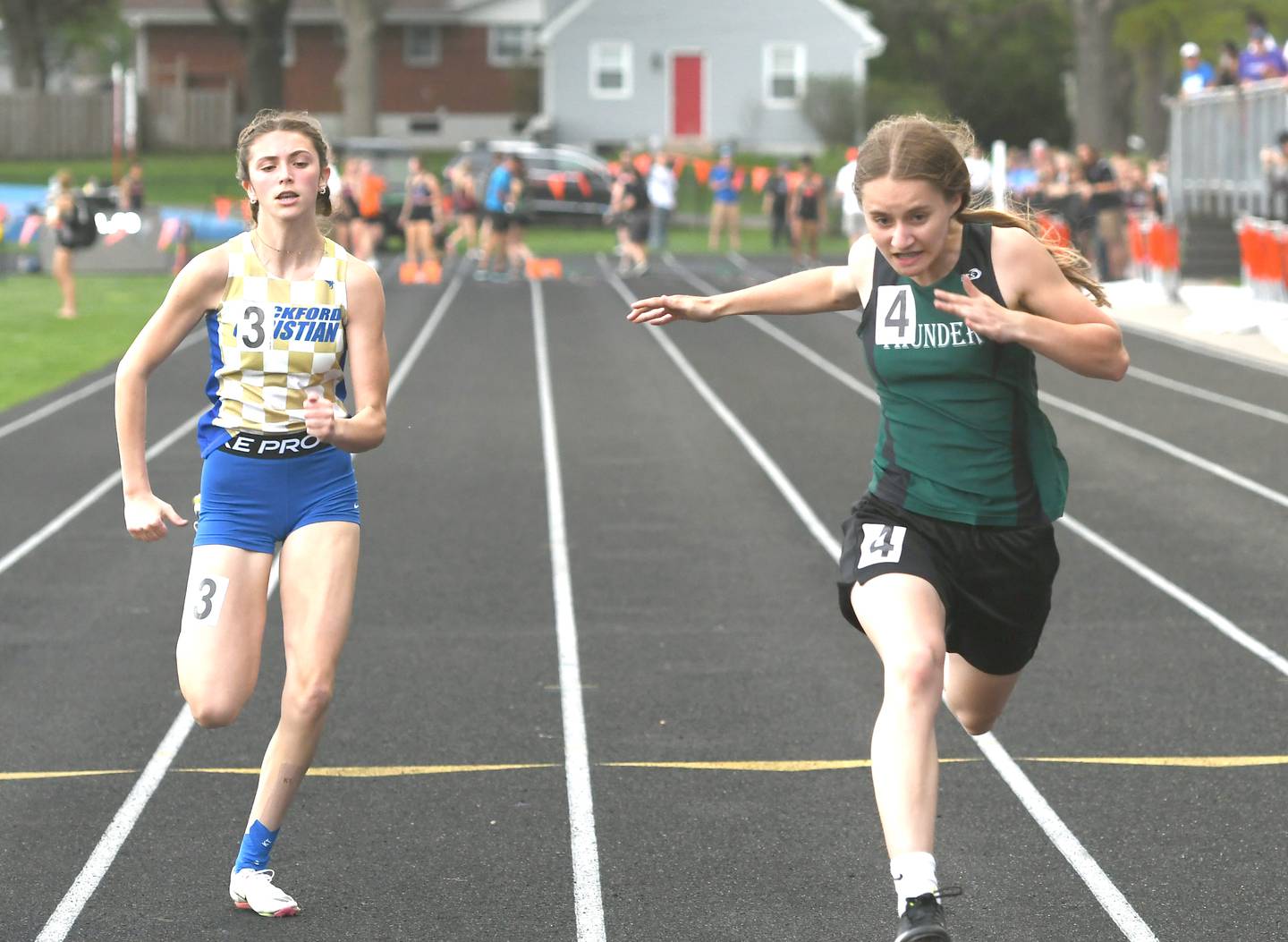 West Carrolll's Emma Randecker (right) crosses the finish line first in the 100 meters at the 1A Winnebago Regional on Friday, May 13. Randecker, a freshman, won the race in 12.73 seconds and will race at the girls state track finals at Eastern Illinois University in Charleston this week.