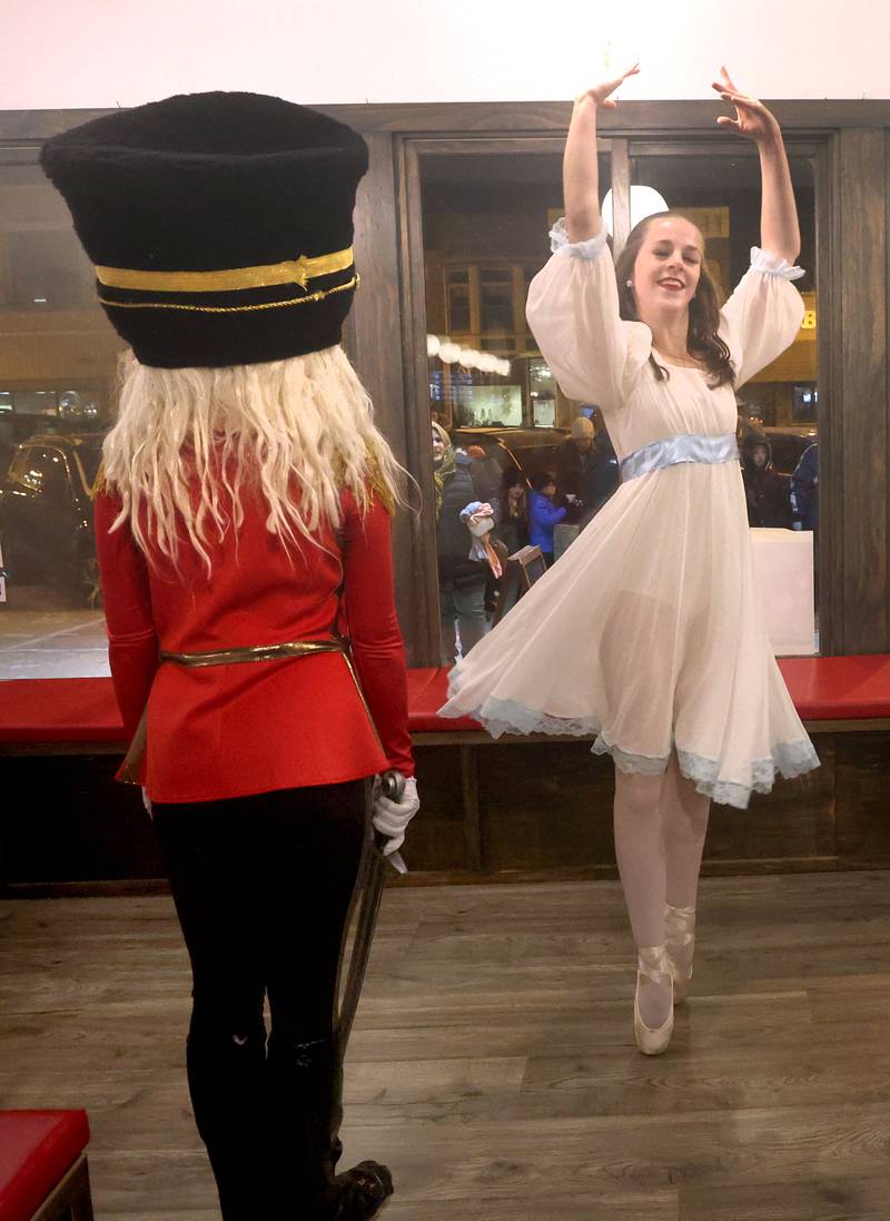 Alexis Green, (right) 15, Addie Gates, (left) 15, and Mekdes Tenth, 16, (not pictured) from the Beth Fowler Dance Company, perform dances from “The Nutcracker” in the window of Pizza Beer Whiskey Friday, Nov. 18, 2022, during the Sycamore Chamber of Commerce's annual Moonlight Magic event in downtown Sycamore.