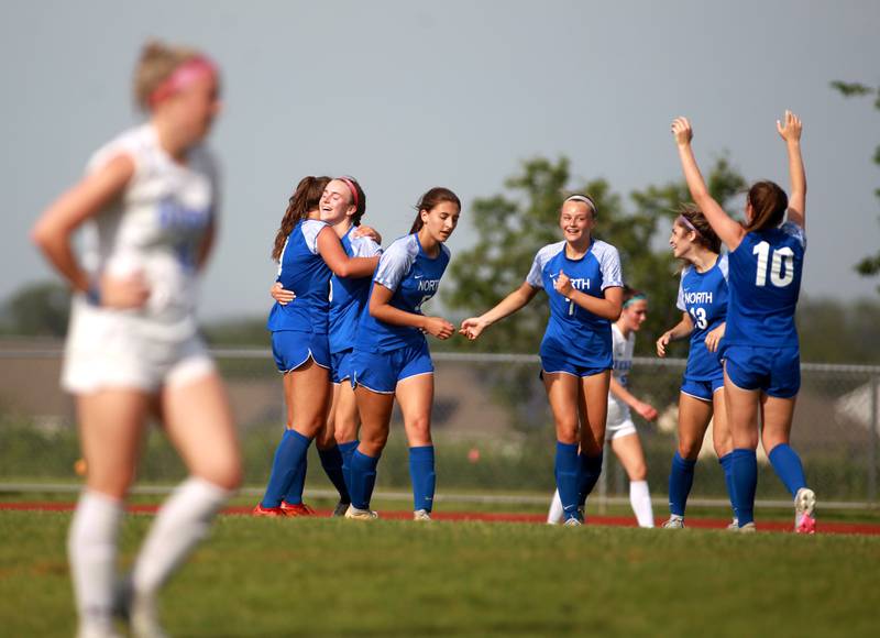 Wheaton North players celebrate a goal by Jane Rogers during a Class 3A South Elgin Sectional semifinal game against Geneva on Tuesday, May 21, 2024.