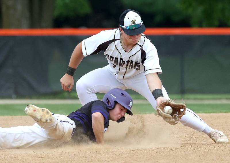 Dixon's Jake Zepezauer just gets back to second safely as Sycamore's Nathan Lojko takes the throw on a pickoff attempt Thursday, May 29, 2025, during their Class 3A regional semifinal game at Freeport High School.