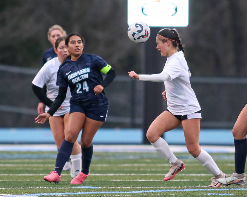 Riverside-Brookfield's Michelle Panduro (4) heads the ball during soccer match between Riverside-Brookfield at Downers Grove South.  April 10, 2025.