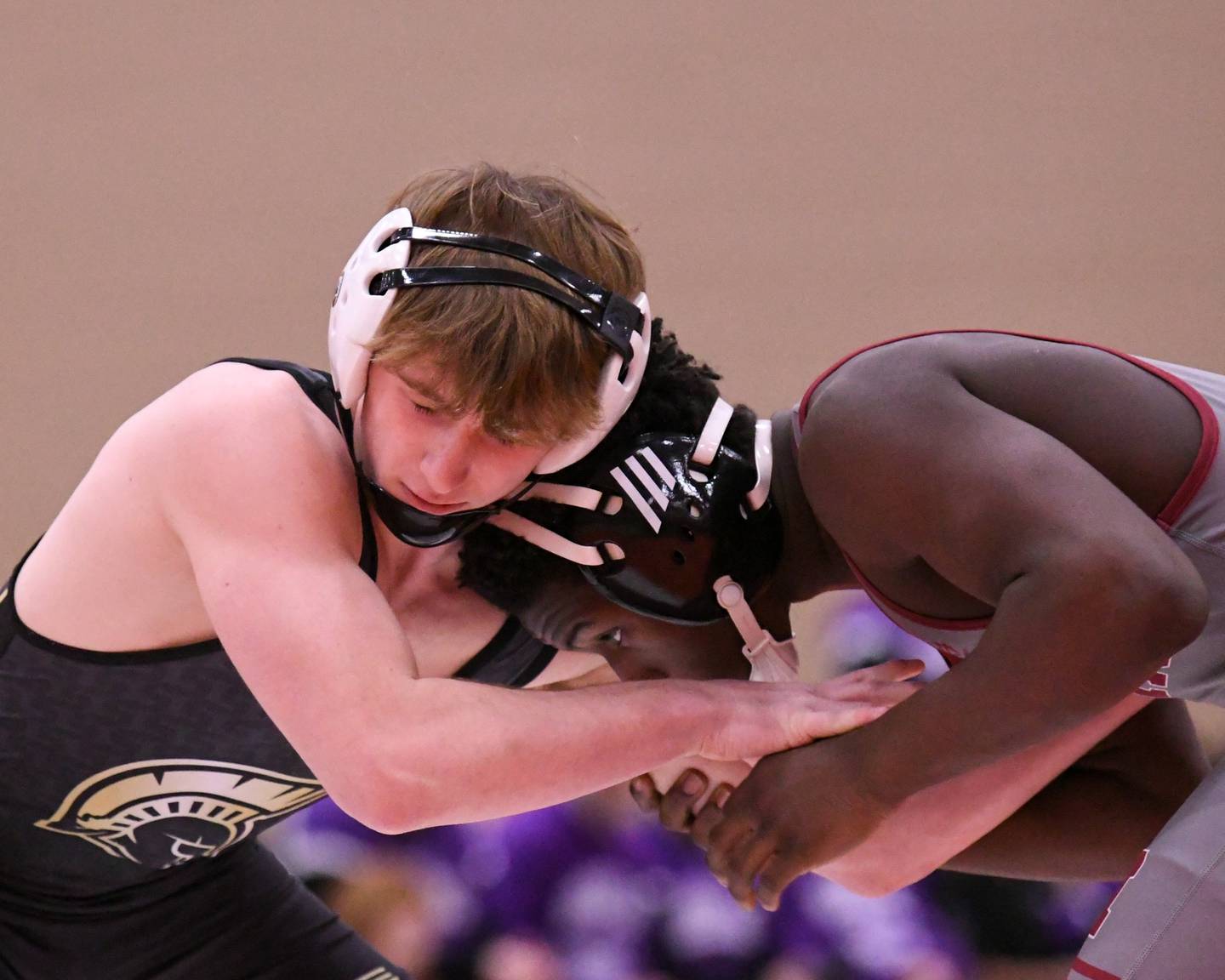 Jayden Dohogne of Sycamore, left, tries to escape the hands of Housseyn Ndiaye of Moline in the 144-weight class during the Flavin Invite on Tuesday Dec. 30, 2025, held at DeKalb High School.