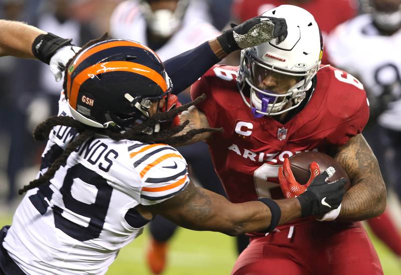 Chicago Bears linebacker Tremaine Edmunds wraps up Arizona Cardinals running back James Conner during their game Sunday, Dec. 24, 2023, at Soldier Field in Chicago.