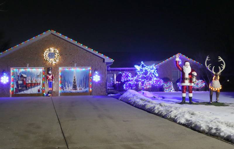 A large Santa and Rudolph fill the lawn of the 1600 block of 27th Street on Wednesday, Dec. 17, 2025 in Peru.