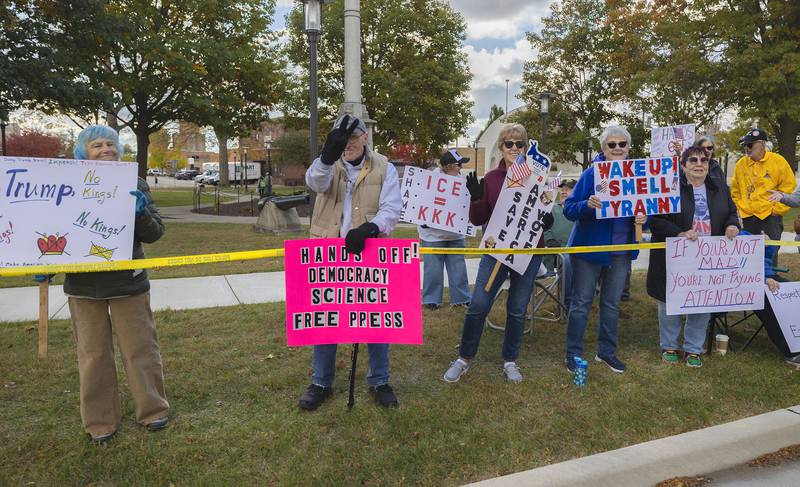 Protestors line up along Fourth Street in Sterling Saturday, Nov. 1, 2025, for another round of No Kings rallies.