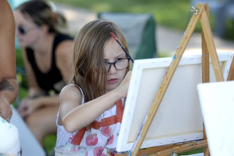 Eloise Gribble, 9, of Sycamore works on a painting of horses during a painting class with Chelsea McGhee Studios at the Little Cottage on the Farm in Kaneville on Thursday, July 27, 2023.