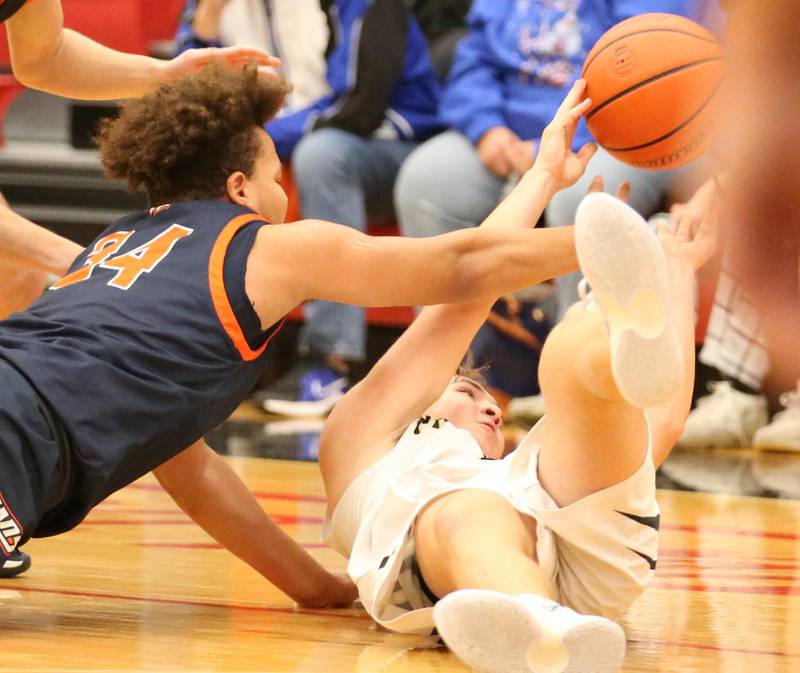 Putnam County's Austin Mattingly (right) goes after a loose ball as Pontiac's Riley Johnson (left) dives to try and gain possession during the Colmone Classic tournament on Friday, Dec. 9, 2022 at Hall High School in Spring Valley.