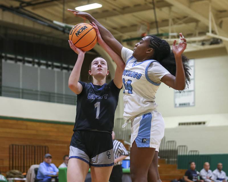 Oswego East's Aubrey Lamberti (1) is challenged by Downers Grove South's Ionna Griffin (14) on a layup attempt during their York Thanksgiving Tournament matchup between Oswego East at Downers Grove South Friday, Nov 20, 2025 in Elmhurst.