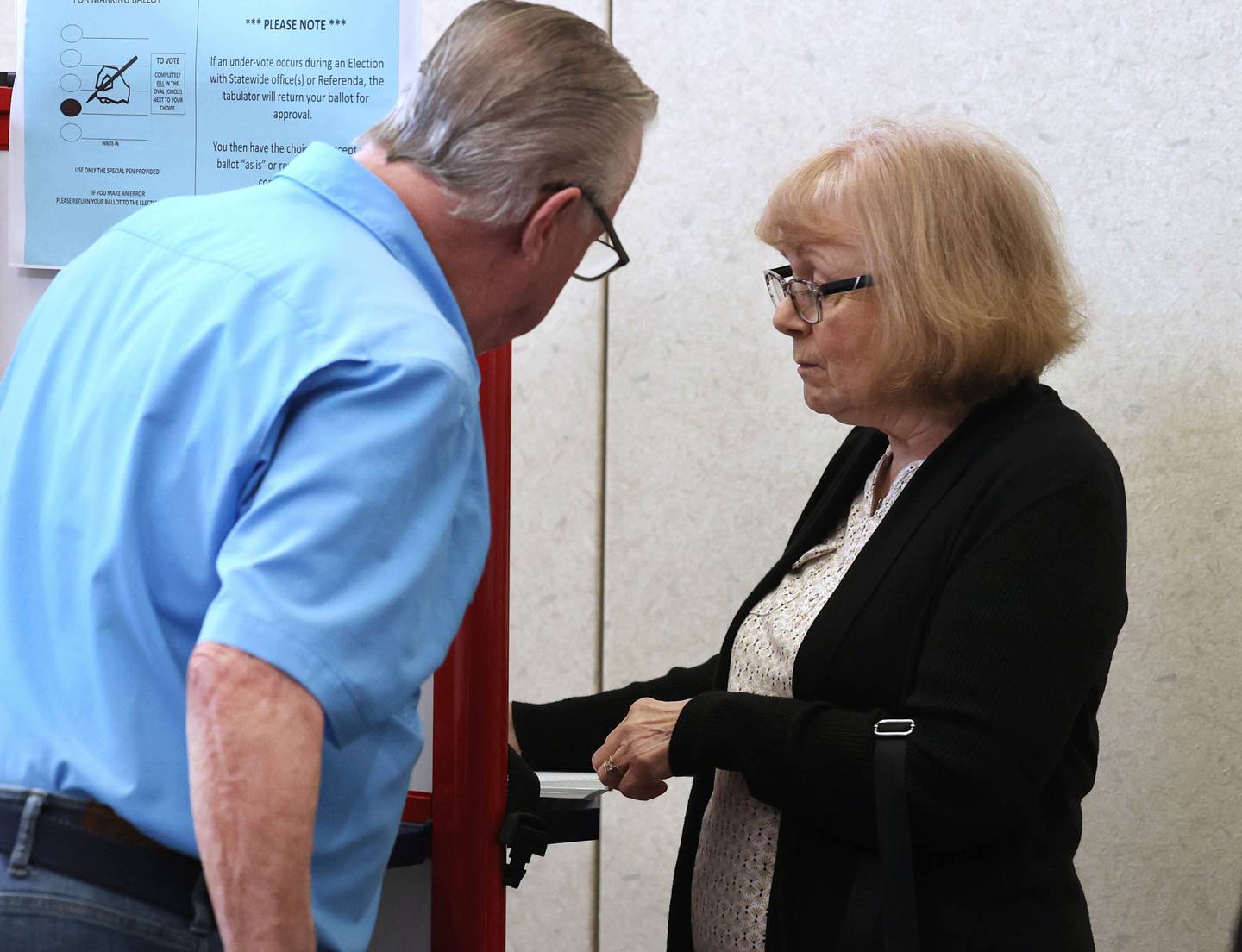 Dan Walker, from Sycamore, checks with his wife Linda as they finish voting Thursday, Sept. 26, 2024, during the first day of early voting for the Nov. election at the DeKalb County Legislative Center in Sycamore.