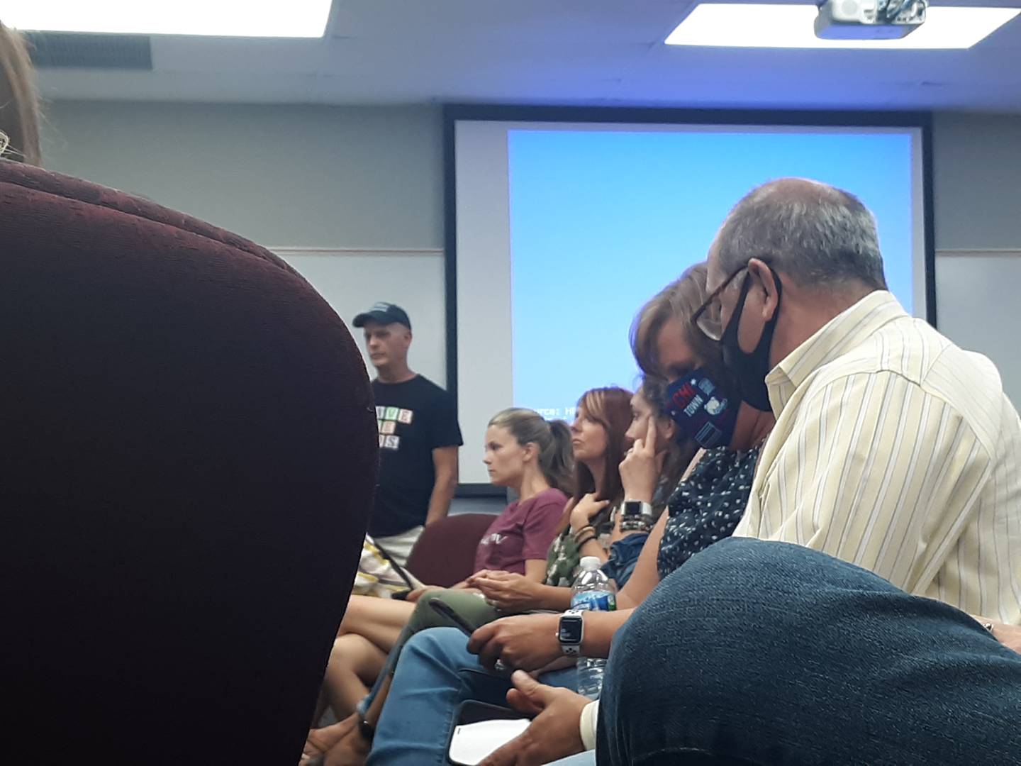 Members of the public sit at a packed Crystal Lake Elementary School District 47 school board meeting on Monday, July 21 2021.