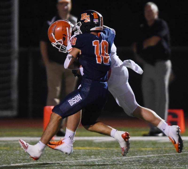 Joe Lewnard/jlewnard@dailyherald.com
Hersey's Logan Farrell, rear, heads to the end zone for a touchdown despite the defensive efforts of Buffalo Grove's Matthew Maradkel during Friday's game in Buffalo Grove.