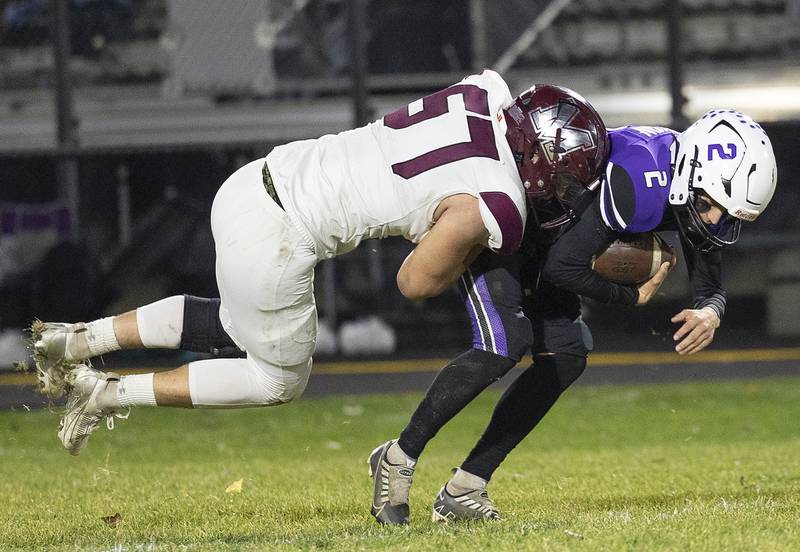 Dixon’s Cullen Shaner is sacked by Marengo’s Brady Kenton Friday, Nov. 1, 2024 in the 4A football playoffs in Dixon.