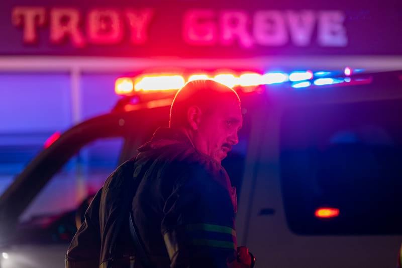 Firefighter looks over shoulder on scene of missing individual involved in rollover accident on Sunday, Aug 31, 2025 at intersection of Route 251 and 46th road in Mendota.