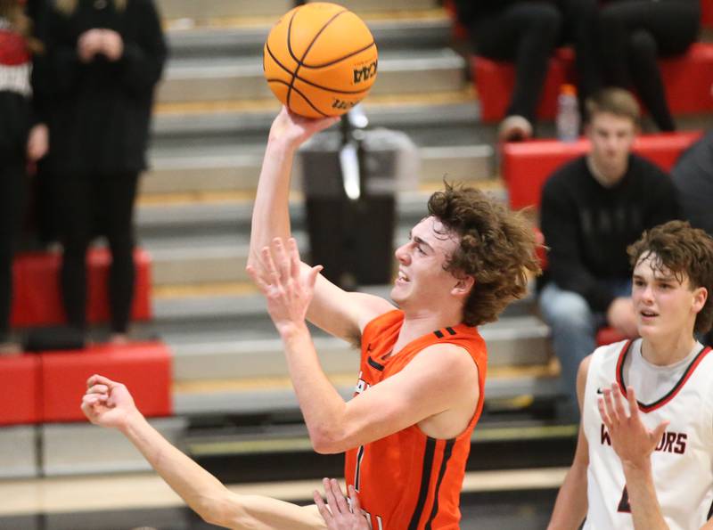 Flanagan-Cornell's Connor Reed drives to the basket past Woodland's Nolan Price during the Route 17 Classic Tournament on Wednesday, Nov. 27, 2024 at Woodland High School.