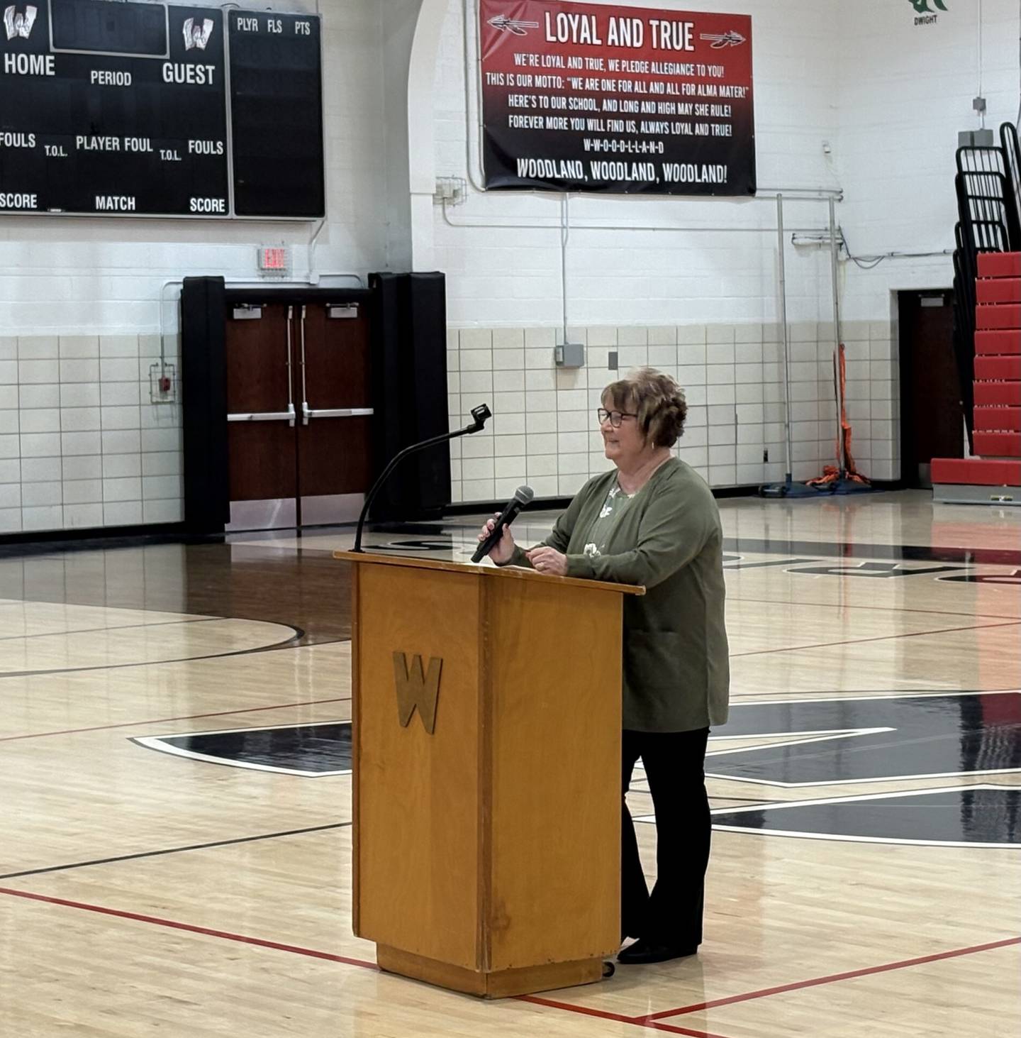 Diana Hallam speaks with Woodland students during the induction ceremony, reflecting on her time at the school and how it inspired her decision to eventually return and give back.