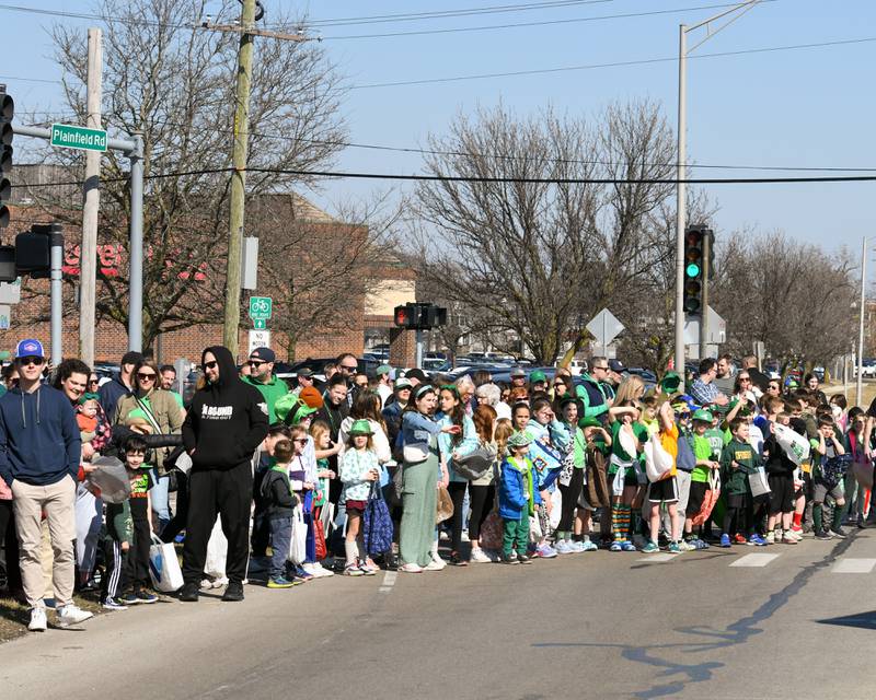 Community members line the street on Plainfield and Brainard for St. Patrick’s Day parade in Countryside on Saturday March 2, 2024.