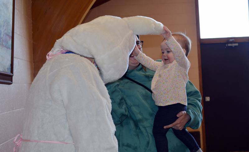 Chloe Wicox, 1, of Rockford, plays with the Easter Bunny's ears from mom Amanda Wicox's arms during the Leaf River Lion's annual Breakfast with Bunny in the Bertolet Memorial Building on April 16.