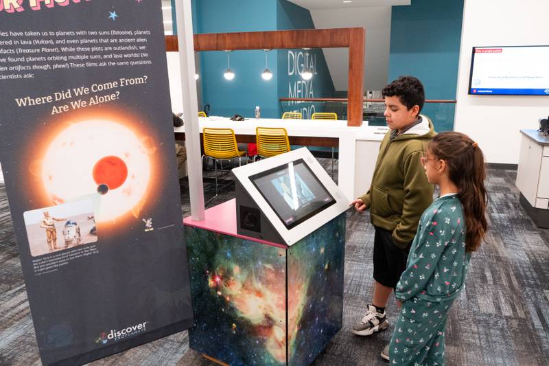 The Joliet Public Library at 150 N. Ottawa St. in Joliet is hosting an all-ages, interactive Exoplanet exhibit from NASA through Feb. 28. Pictured are Miranda Espina and Joshua Ramirez.