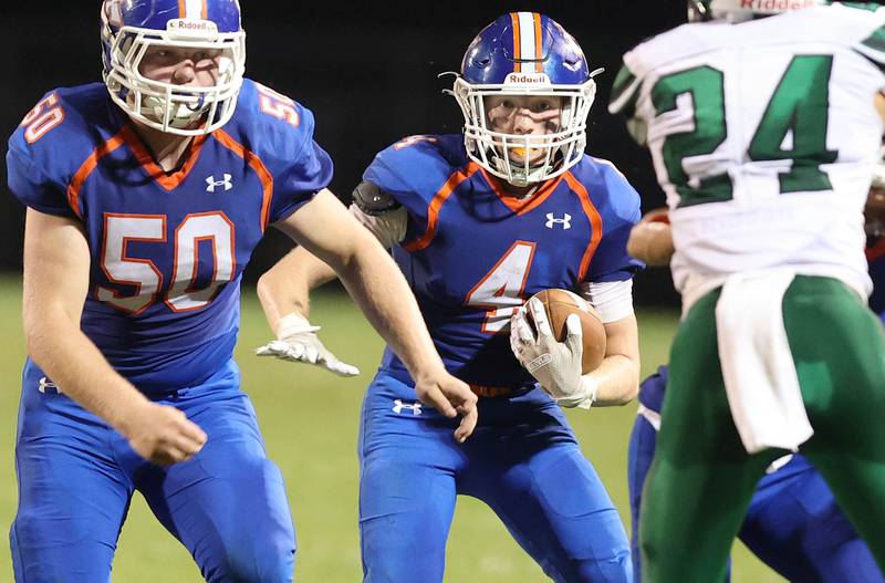 Genoa-Kingston's Ethan Wilnau carries the ball behind Evan Thompson during their game against North Boone Friday, Sept. 9, 2022, at Genoa-Kingston High School.