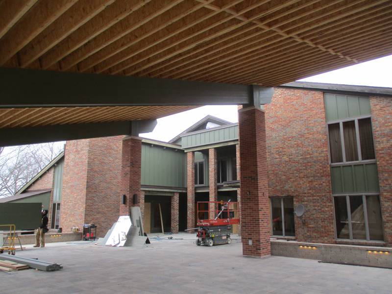 The renovated exterior of the Pickerill home is seen from under the roof of the new pavilion on March 2, 2023 at the Pickerill-Pigott Forest Preserve in unincorporated Yorkville.