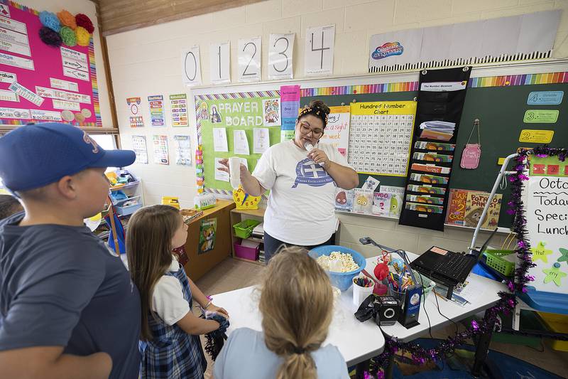 St. Anne’s teacher Sydney Ybarra leads the group in testing their volume vessels Thursday, October 10, 2024.