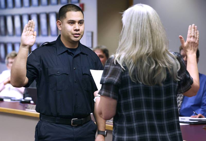 New Sycamore firefighter Carlos Aburto is officially sworn in as a firefighter by city clerk Mary Kalk Monday, April 1, 2024, during the Sycamore City Council meeting in the chambers at Sycamore Center.