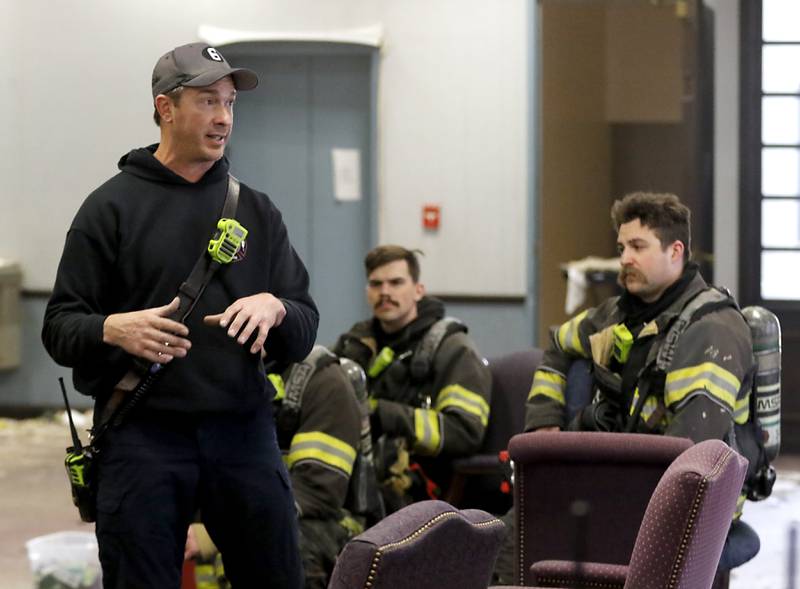 McHenry Fire Department instructor Kevin Sears  teaches firefighters on Tuesday April 15, 2025, during a RIT crew and chief divisional drill with other firefighters from area departments in a former bank building in Downtown McHenry.