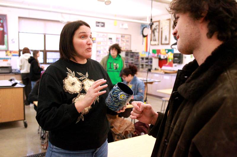 St. Charles North Art Teacher Stephanie Dodd talks with one of her advanced placement art students, Vinnie Buttitta.