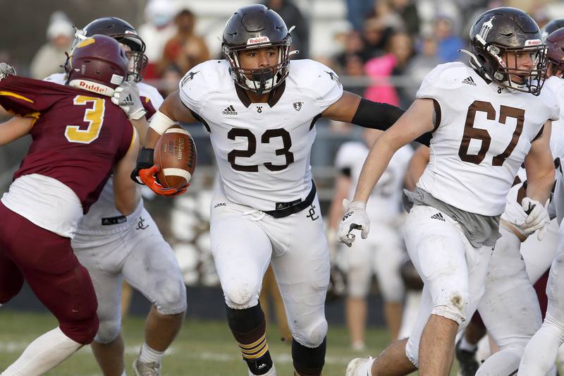 Joliet Catholic's Jordan Anderson gets help with blocking to clear a route for the ball during their IHSA Class 4A semifinal football game on Saturday, Nov. 20, 2021 at Richmond-Burton High School in Richmond. Joliet Catholic won 35-18, delivering Richmond-Burton their first loss in three years.