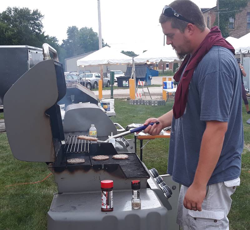 Nicholas Angelakos served as the volunteer grill master Wednesday, Aug. 3, 2022, during welcome burger at Seneca's Shipyard Days. Angelakos said his family volunteered for the event.