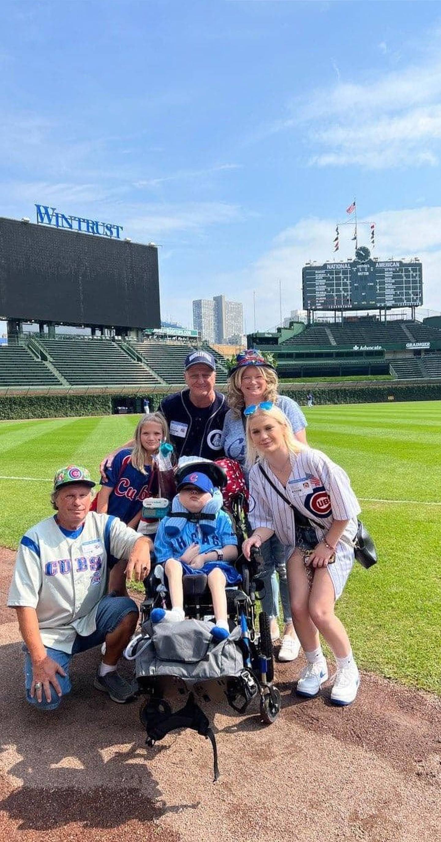 Lifelong Cubs fan Jonathan Wrigley Hardy, 13, of Joliet,  received the VIP treatment on Thursday, Aug. 25, 2022, as an Honorary Cubs Bat Kid at his first-ever Cubs game. He is pictured with his family. They are (from left) his grandfather Bill Smith, sister Gwendolyn Hardy, 9; father John Hardy; mother Kandi Hardy; and sister Lillian Hardy, 16.