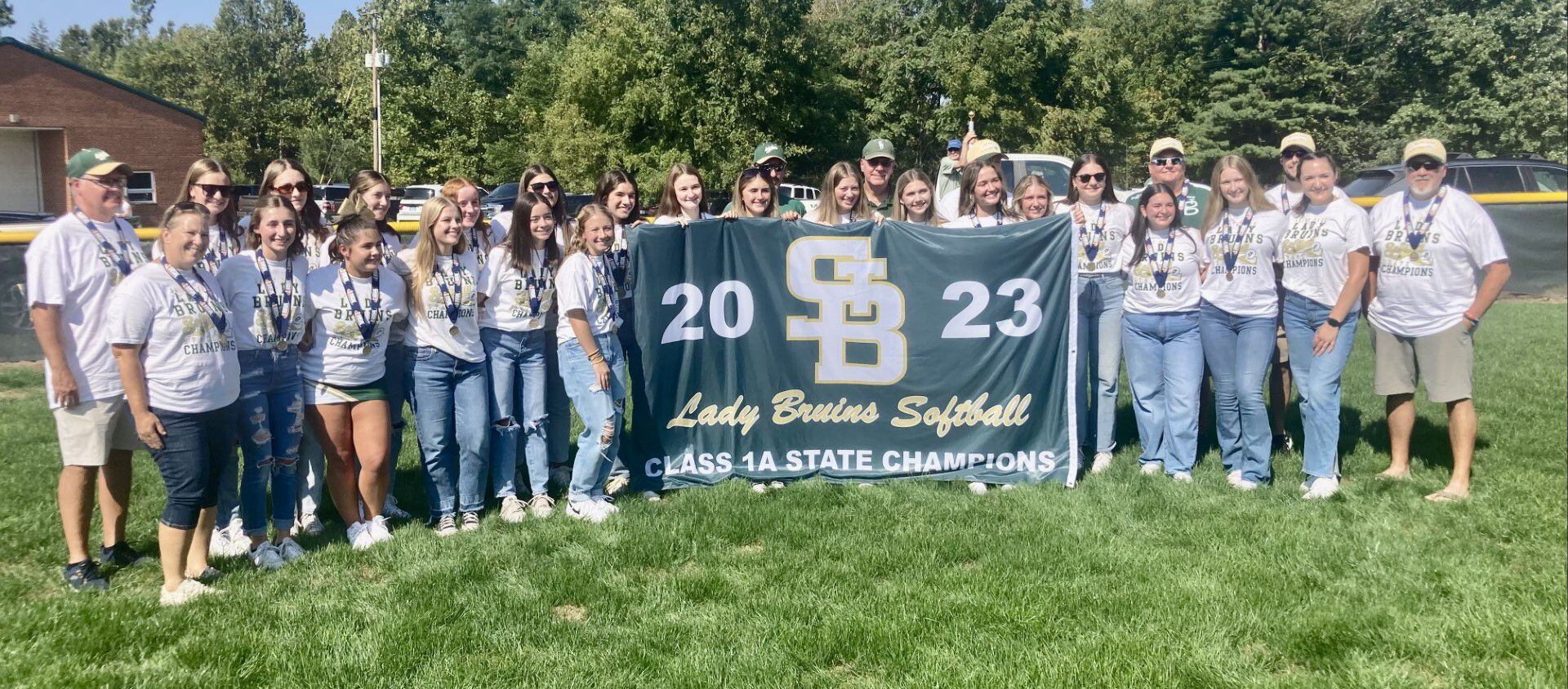 The St. Bede softball team display their 2023 Class 1A state championship banner at Abbot Philip Davey Field Saturday. St Bede rallied to unseat two-time defending state champion Glasford Illini Bluffs, 7-6, on June 3.