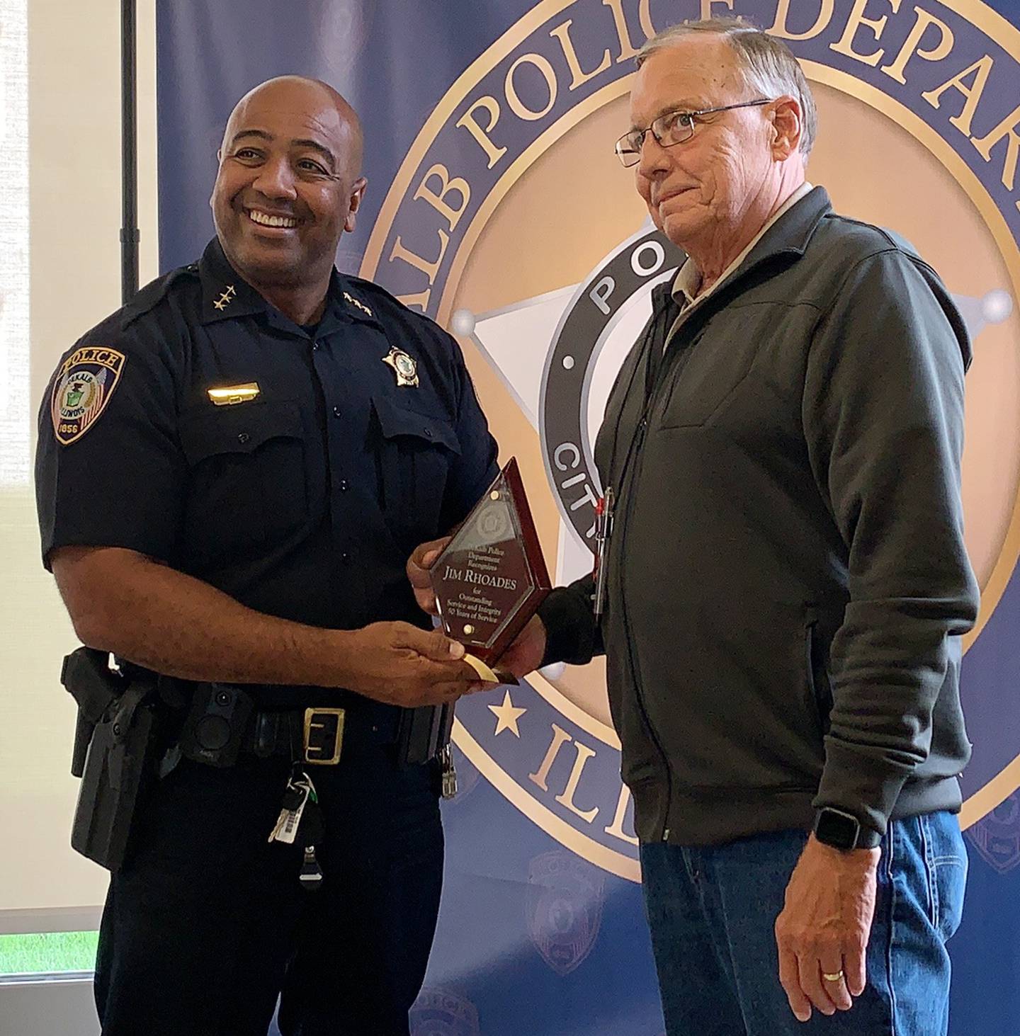 DeKalb Police Department chief David Byrd (left) honoring Jim Rhoades for 50 years of service
