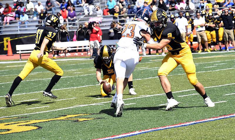Joliet West's Matthew Prieboy gets ready to kick a field goal as Jaxon Aubry holds during the first half Saturday against Oswego at Joliet West. The 36-yard field goal would be West's only score as it lost to Oswego, 7-3.
