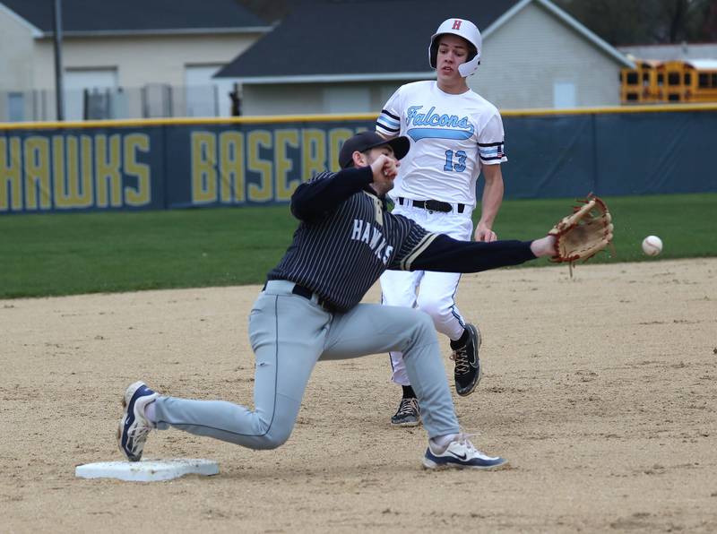 Parkview Christian Academy's Christian Mulder is safe at third as the throw gets by Hiawatha's Aidan Cooper Thursday, April 17, 2025, during their game at Hiawatha High School in Kirkland.