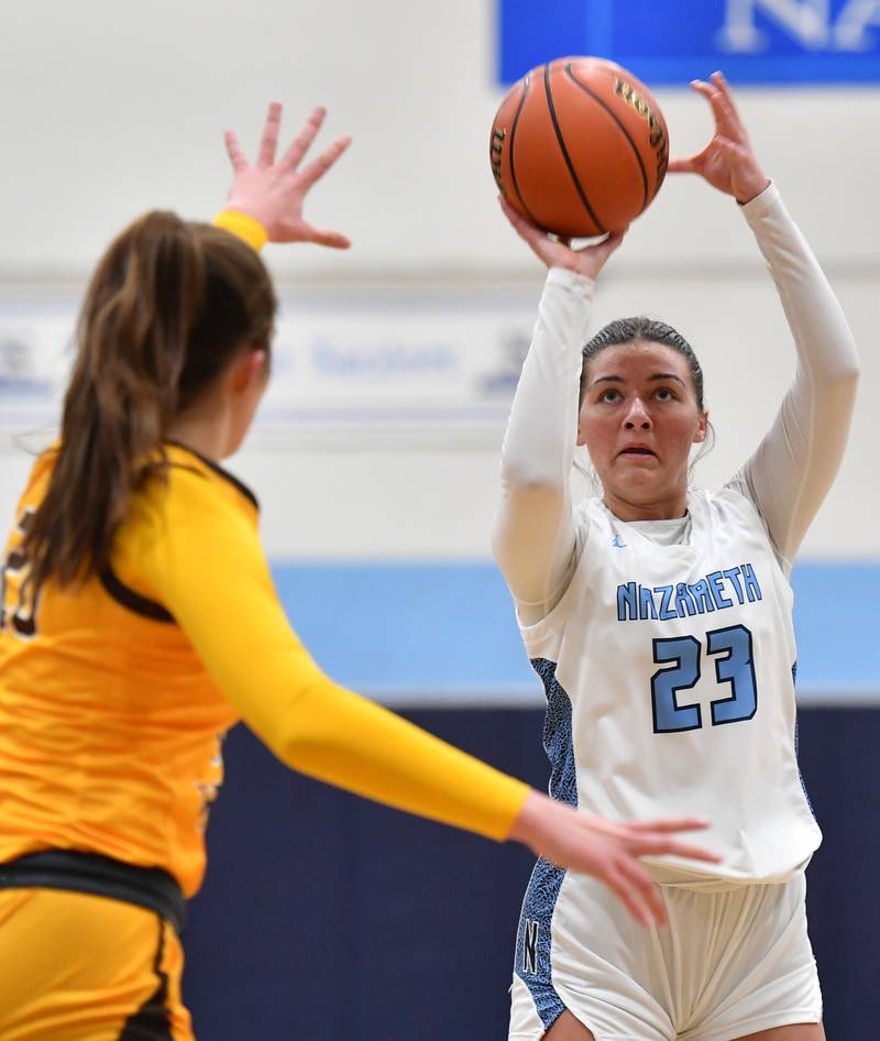 Nazareth's Danielle Scully (23) shoots over a Carmel defender during the ESCC conference tournament championship game on Feb. 4, 2023 at Nazareth Academy in LaGrange Park.