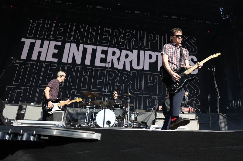 Kevin Bivona of The Interrupters takes front stage for a guitar solo on the Riot Stage on day one of Riot Fest, Friday, Sept. 15, in Chicago.