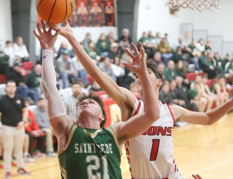 LaMoille's Tyler Billhorn tips the ball away from St. Bede's Guss Burr under the hoop on Tuesday, Feb. 11, 2025 at LaMoille High School.