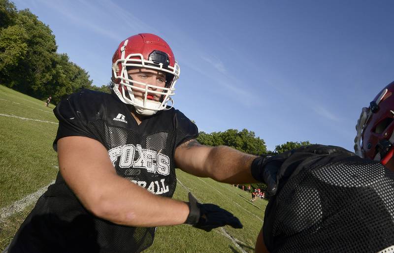 Lineman Andrew Laurich practices arm skills during rushing drills at a football practice at Yorkville High School on Friday, August 12, 2022.