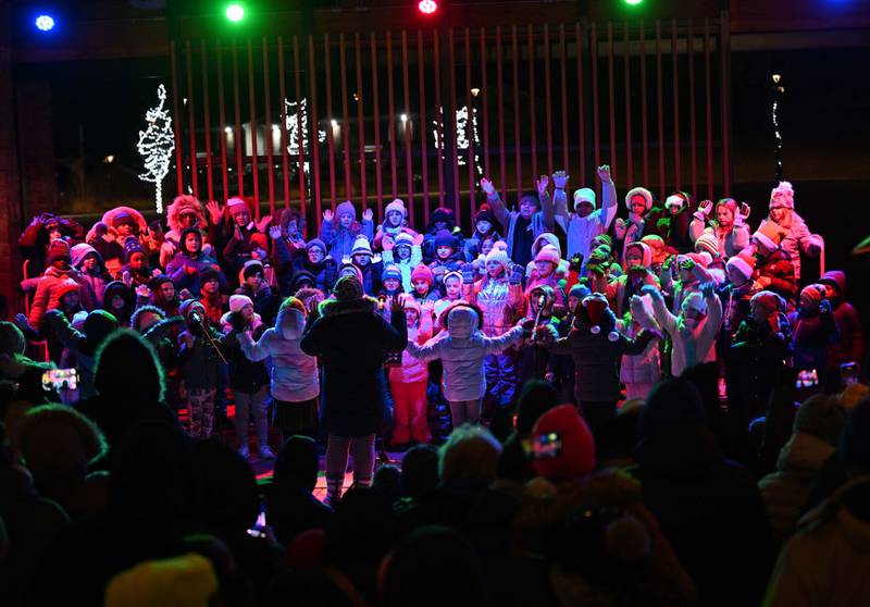 Alan Shepard Elementary third-graders, under the direction of Emily Heald, perform on Thursday during the inaugural Rockin’ Around the Tree Lighting at The Grove in Bourbonnais.
