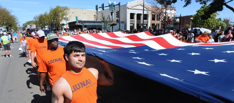 Marseilles Local 393 marches with a large American flag along LaSalle St  Ottawa Sunday during the Fall Fest Parade.